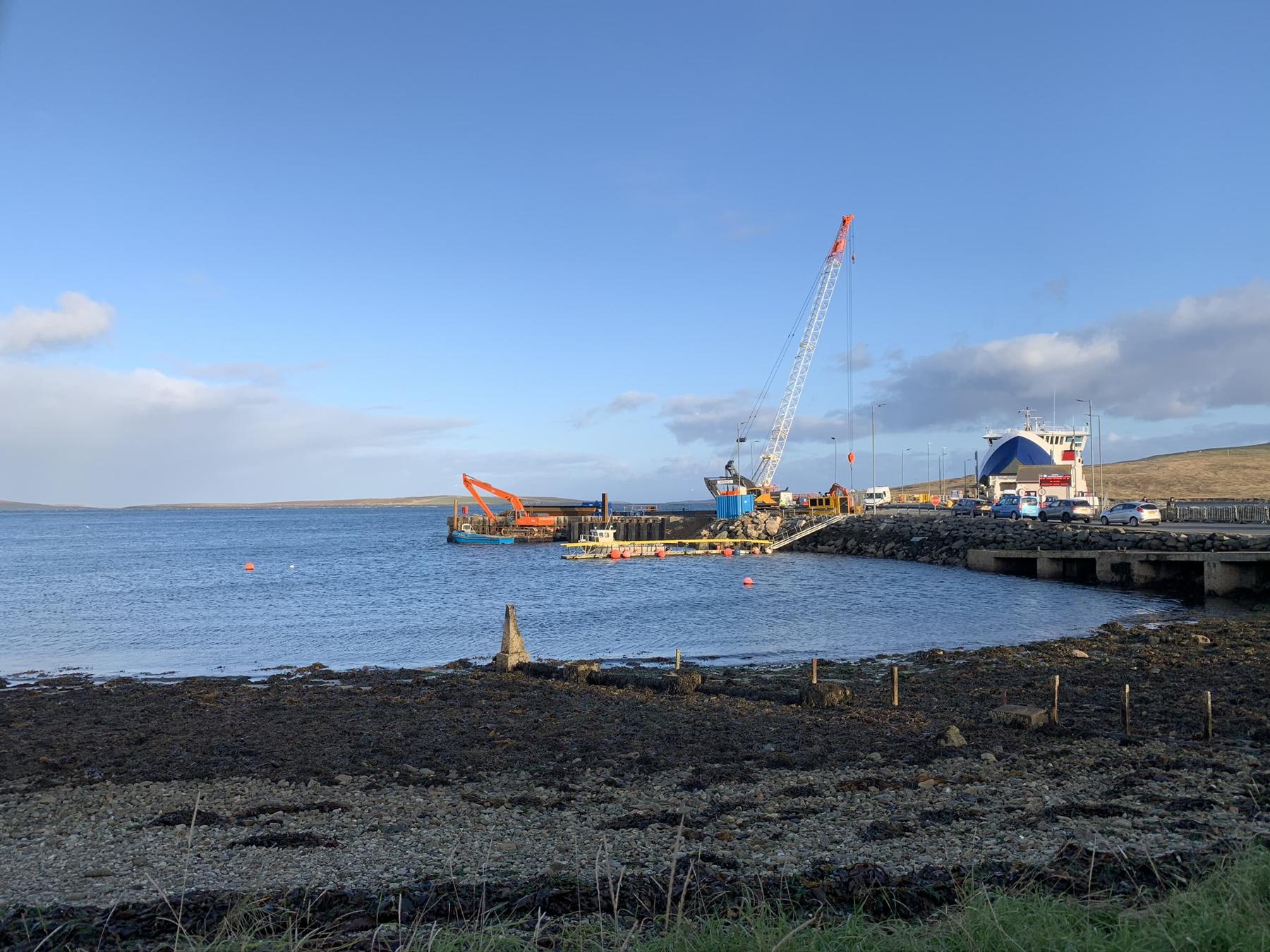 Crawler crane and long-reach excavator working on a terminal extension